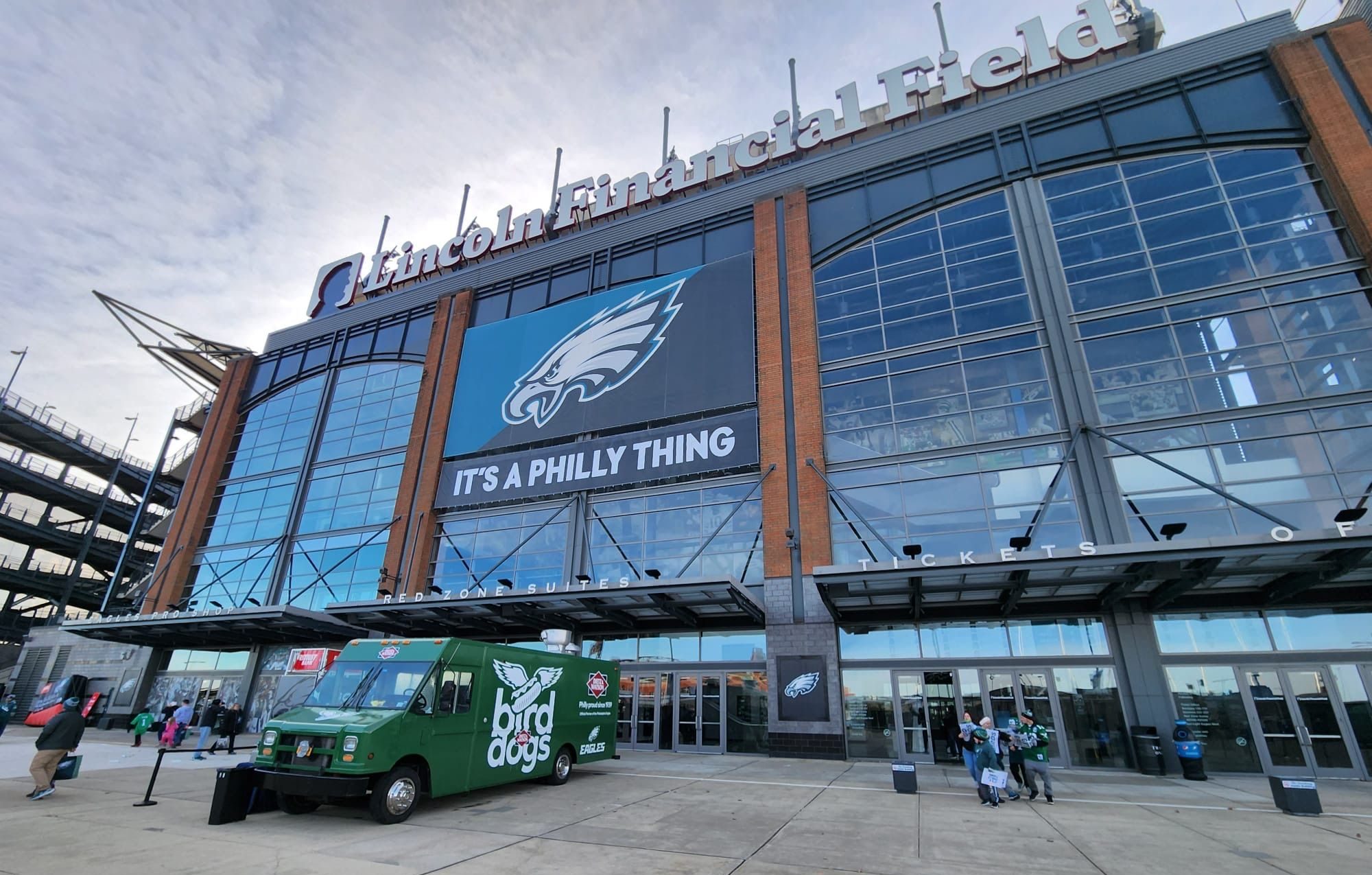 Lincoln Financial Field with Eagles logo, “It’s a Philly Thing” sign, and green truck at entrance.