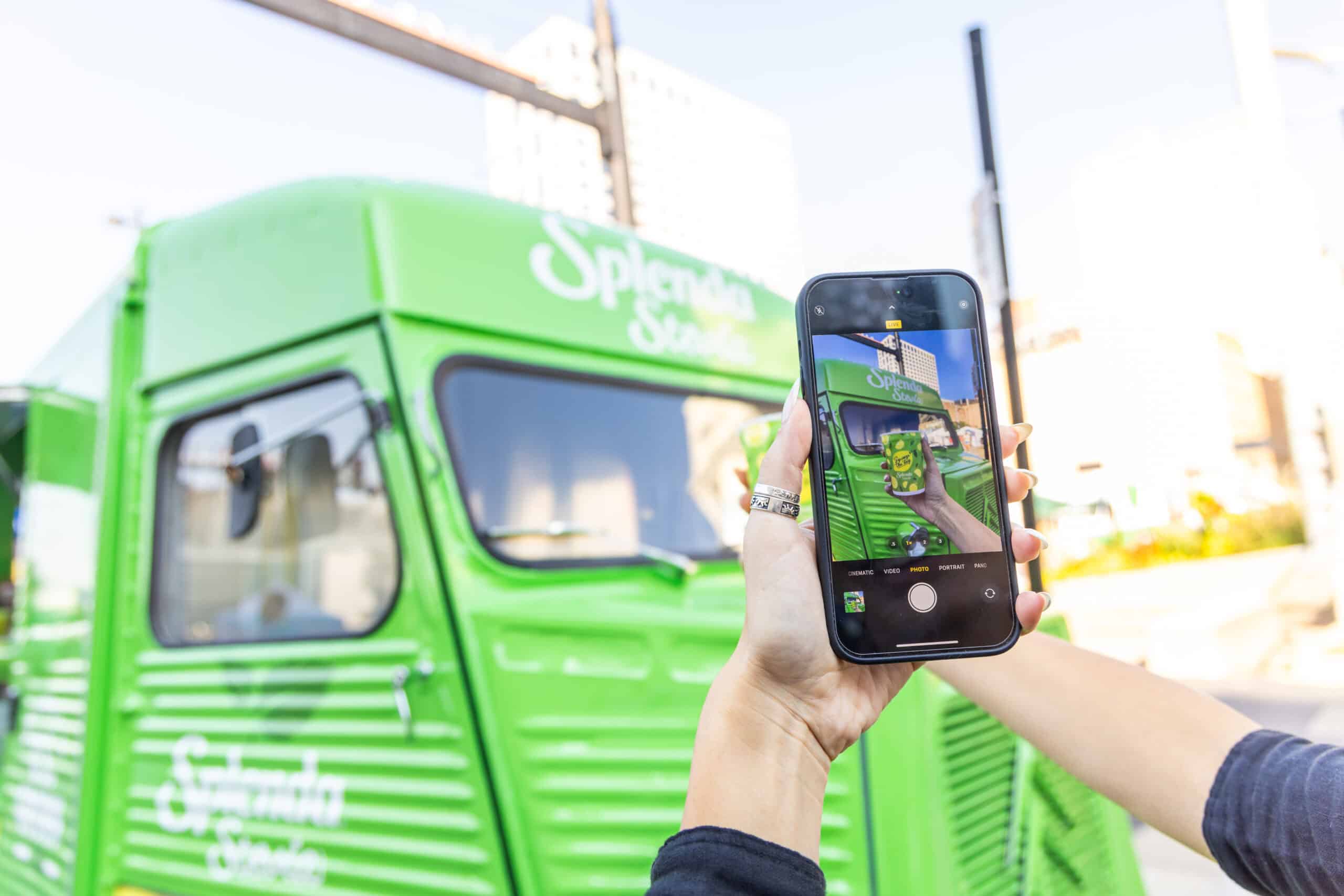 an iphone taking a photo of a splenda cup at a popup truck