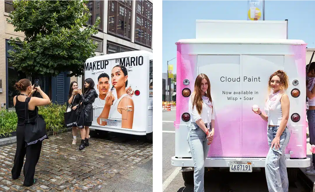 Two photos: Left, a group of women take pictures of a white Experiential Marketing Vehicle with a "MAKEUP BY MARIO" ad. Right, two women stand smiling in front of a pink-and-white van advertising "Cloud Paint.