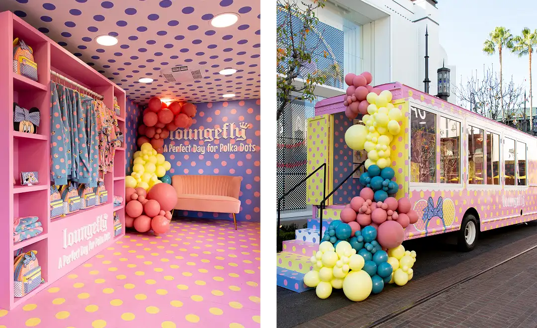 A split image shows a colorful polka-dot-themed pop-up shop with Loungefly merchandise, balloons, and seating on the left, and a pink and yellow polka-dot decorated bus with balloon clusters outside on the right.