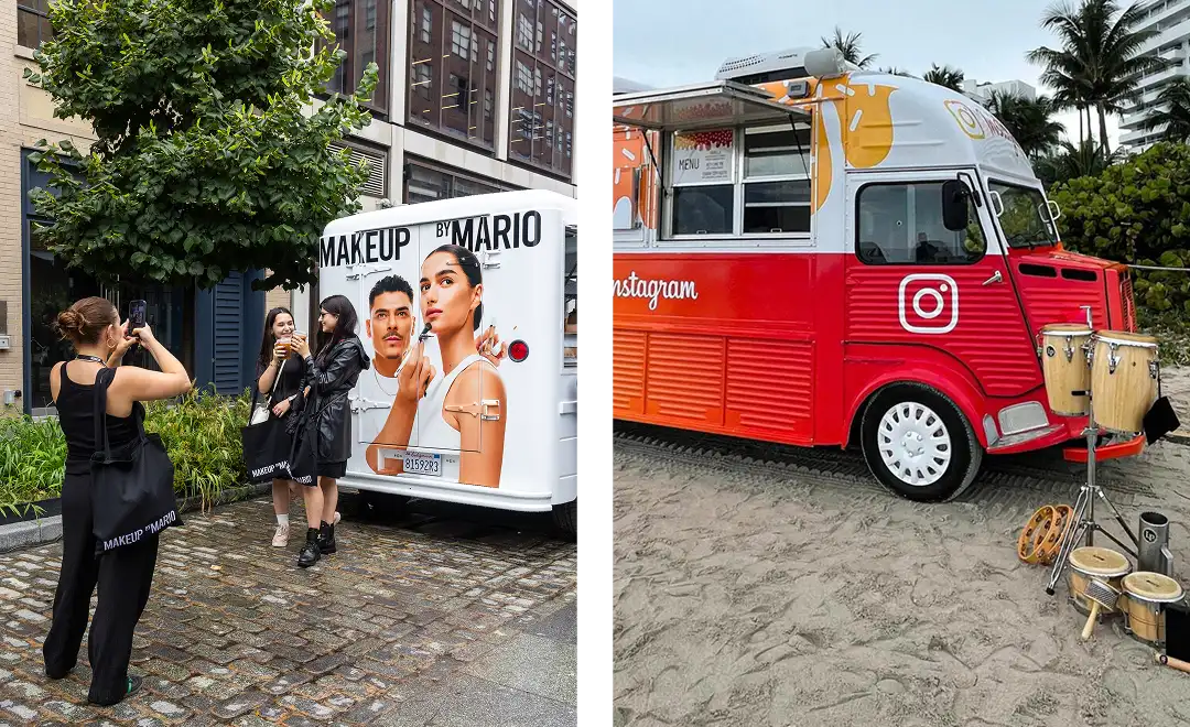 Two colorful food trucks parked outdoors: one white with "MAKEUP BY MARIO" and models' faces, where people pose for photos; the other red with an Instagram logo, set on sand with percussion instruments nearby.