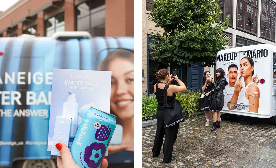 A hand holds Laneige Water Bank skincare pamphlets and a can of Poppi drink in front of promotional trucks, while nearby, three people pose for a photo by a Makeup by Mario van on a bustling city street.